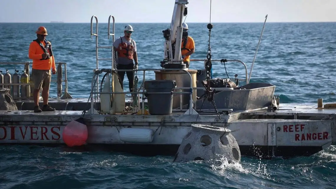 The Reef Ranger vessel and crew preparing to deploy a memorial reef offshore.